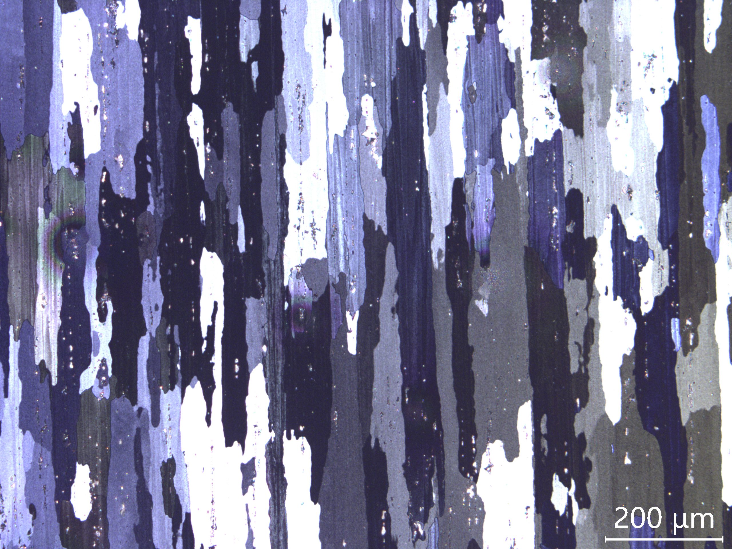 Micrograph of a layered material showing varying shades of blue, purple, and white, highlighting texture and structure at a scale of 200 µm.