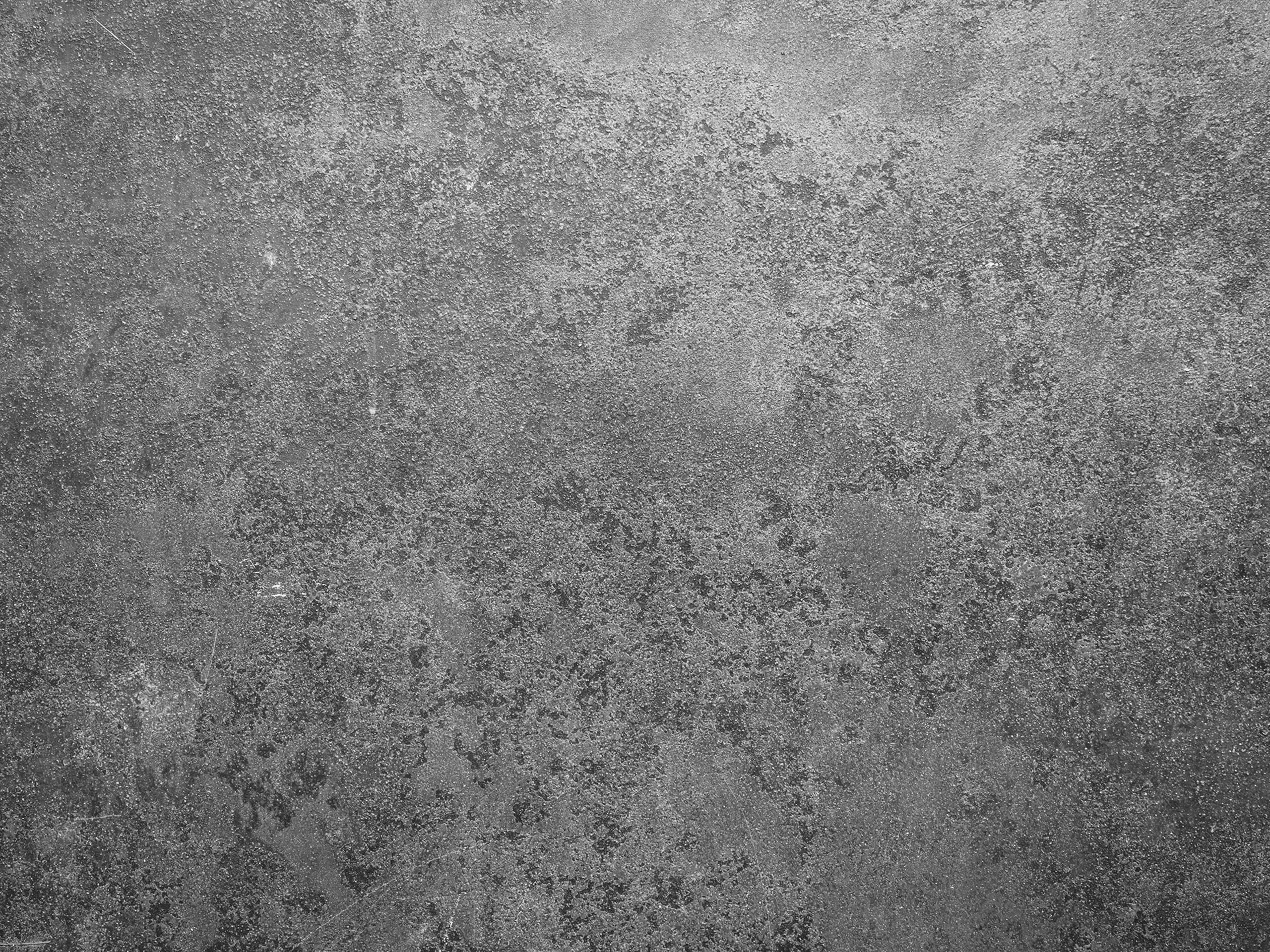 Textured gray concrete surface showcasing subtle variations and imperfections, ideal for backgrounds in design or architectural projects.