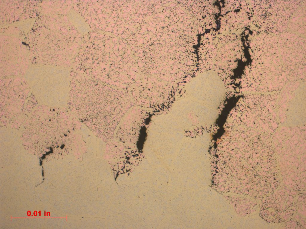 Close-up of a piece of paper featuring a black and pink design, highlighting the contrast between the two colors.